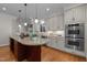 Bright kitchen features an island with granite counters and stainless steel appliances at 1003 Gloucester Ct, Chapel Hill, NC 27516