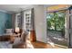 Cozy living room with natural light, comfortable seating, and hardwood floors at 1003 Gloucester Ct, Chapel Hill, NC 27516