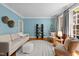 Comfortable living room with light blue walls, hardwood floors, and lots of natural light from the windows at 1003 Gloucester Ct, Chapel Hill, NC 27516