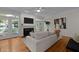 Inviting living room with a fireplace, hardwood floors, and French doors to outdoor space at 1003 Gloucester Ct, Chapel Hill, NC 27516