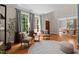 A cozy living room featuring a round rug, two chairs, and natural light streaming through the large windows at 1003 Gloucester Ct, Chapel Hill, NC 27516