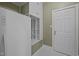 Mudroom features white appliances, cabinets, and a white door with brass hardware at 1003 Gloucester Ct, Chapel Hill, NC 27516