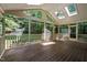 Sunroom with vaulted ceilings, skylights and screened windows with wooded view at 1003 Gloucester Ct, Chapel Hill, NC 27516