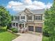 Aerial view of the home with well-manicured lawn and mature trees at 1008 Wolfs Bane Dr, Apex, NC 27539