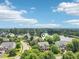 An aerial view of a residential neighborhood with a pond, mature trees and beautiful landscaping at 1008 Wolfs Bane Dr, Apex, NC 27539