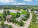 Beautiful aerial view of a neighborhood surrounding a pond with mature trees and green spaces at 1008 Wolfs Bane Dr, Apex, NC 27539