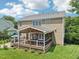 The backyard is spacious with a large deck, patio, and well maintained lawn at 1008 Wolfs Bane Dr, Apex, NC 27539
