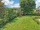 Backyard view including a playset and lush landscaping at 1008 Wolfs Bane Dr, Apex, NC 27539