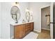 Double vanity bathroom with matching framed mirrors and cabinet storage at 1008 Wolfs Bane Dr, Apex, NC 27539
