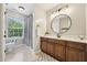 Well-lit bathroom with vanity, decorative mirror, and neutral tones creates a serene atmosphere at 1008 Wolfs Bane Dr, Apex, NC 27539