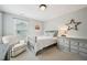 Inviting bedroom features a cozy chair, dresser, and soft lighting for a serene ambiance at 1008 Wolfs Bane Dr, Apex, NC 27539
