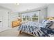Bright bedroom featuring a window view, a wooden dresser, and built-in shelves for storage at 1008 Wolfs Bane Dr, Apex, NC 27539
