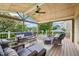 Inviting covered deck with wicker furniture, ceiling fan, and string lights at 1008 Wolfs Bane Dr, Apex, NC 27539