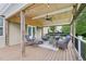 Comfortable covered deck area with wicker furniture and ceiling fan at 1008 Wolfs Bane Dr, Apex, NC 27539