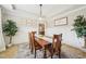 Inviting dining room with wood table, stylish rug, and wainscoting at 1008 Wolfs Bane Dr, Apex, NC 27539