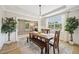 Open-concept dining area features a wooden table with bench and chairs at 1008 Wolfs Bane Dr, Apex, NC 27539