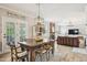 Welcoming dining area open to the living area, wood floors and table at 1008 Wolfs Bane Dr, Apex, NC 27539