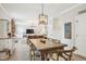 Charming dining area showcasing an ample wood table open to the living area at 1008 Wolfs Bane Dr, Apex, NC 27539