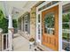 Close-up of the front entrance with a decorative wooden door and brick siding at 1008 Wolfs Bane Dr, Apex, NC 27539
