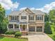 Beautiful two-story home with brick accents, a front porch, and a two-car garage at 1008 Wolfs Bane Dr, Apex, NC 27539