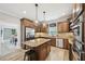 Gourmet kitchen with granite island, stainless steel appliances, and wood cabinets at 1008 Wolfs Bane Dr, Apex, NC 27539