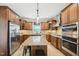 Spacious kitchen with stainless steel appliances and a central island at 1008 Wolfs Bane Dr, Apex, NC 27539