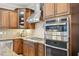 Close-up of a modern kitchen with stainless steel appliances and custom cabinetry at 1008 Wolfs Bane Dr, Apex, NC 27539