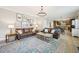 Spacious living room with leather sofas, decorative rug, and open layout to the kitchen at 1008 Wolfs Bane Dr, Apex, NC 27539
