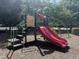 Neighborhood playground with a red slide and monkey bars for children to play on at 1008 Wolfs Bane Dr, Apex, NC 27539