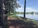 Peaceful view of a lake with trees and a fountain visible in the background at 1008 Wolfs Bane Dr, Apex, NC 27539