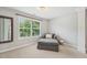Sitting area featuring a chaise lounge with throw pillow and large window views at 1008 Wolfs Bane Dr, Apex, NC 27539
