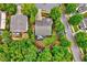 Aerial view of a home surrounded by trees, showcasing the backyard, deck, and location within a neighborhood at 101 Ironcreek Pl, Apex, NC 27539