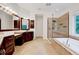 Luxurious bathroom with a soaking tub, glass-enclosed shower, and vanity with dual sinks at 101 Ironcreek Pl, Apex, NC 27539
