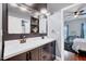 Elegant bathroom showcasing a double vanity, modern fixtures, and mirrors adjacent to a well-lit bedroom at 101 Ironcreek Pl, Apex, NC 27539
