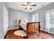 Charming bedroom featuring hardwood floors and a ceiling fan with light at 101 Ironcreek Pl, Apex, NC 27539