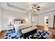 Bright bedroom with large bed, ceiling fan, and hardwood floors, offering style and comfort at 101 Ironcreek Pl, Apex, NC 27539