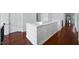 Hallway with hardwood floors, white trim, and natural light, offering a clean and modern aesthetic at 101 Ironcreek Pl, Apex, NC 27539
