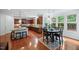 Open kitchen with dark cabinets, granite countertops, a breakfast nook, and natural light at 101 Ironcreek Pl, Apex, NC 27539