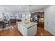 Open concept kitchen with a large island, stainless appliances, and seamless flow to living spaces at 101 Ironcreek Pl, Apex, NC 27539