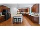 Spacious kitchen with dark wood cabinets, stainless steel appliances, and granite island at 101 Ironcreek Pl, Apex, NC 27539