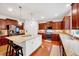 Spacious kitchen boasts granite countertops, stainless steel appliances, and custom cabinetry with hardwood floors at 101 Ironcreek Pl, Apex, NC 27539