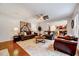 Cozy living room with hardwood floors, neutral paint, ceiling fan, and a view into the kitchen at 101 Ironcreek Pl, Apex, NC 27539