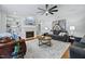 Bright living room featuring built-in shelving, a fireplace, and a comfortable seating area at 101 Ironcreek Pl, Apex, NC 27539