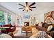 Cozy living room with built-in bookshelves, a fireplace, plush seating, and lots of natural light at 101 Ironcreek Pl, Apex, NC 27539