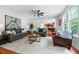 Comfortable living room with plush sofas, ceiling fan, and plenty of natural light at 101 Ironcreek Pl, Apex, NC 27539