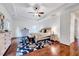 Bright bedroom featuring tray ceilings, hardwood floors, a ceiling fan, and lots of space at 101 Ironcreek Pl, Apex, NC 27539