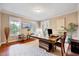 Well-lit office space with a large desk, neutral decor, and a view of the outdoors at 101 Ironcreek Pl, Apex, NC 27539