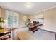 Bright home office featuring a modern desk, neutral walls, and access to the outdoors at 101 Ironcreek Pl, Apex, NC 27539