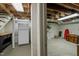 Basement area with a peg board, refrigerator, shelving, and storage at 1015 Watts St, Durham, NC 27701