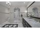 Luxurious bathroom with marble shower, double vanity and black and white checkered floor at 1015 Watts St, Durham, NC 27701